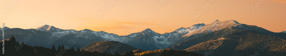 Beautiful panoramic photo of autumn mountain valley at sunset. Amazing sunset in the mountains, autumn in the mountains. Travel and hik concept.