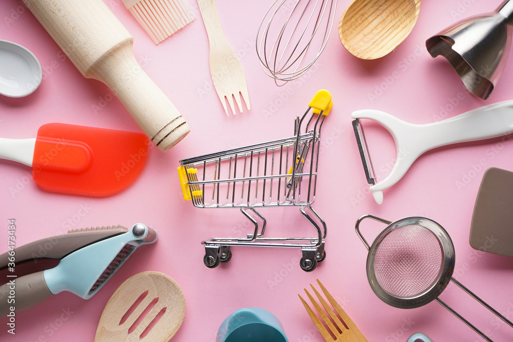 Various kitchen utensils on a pink background, flat lay. Various kitchen utensils on a pink background, flat lay.