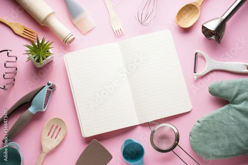 Kitchen utensils on a pink background with space for text. Flat lay.