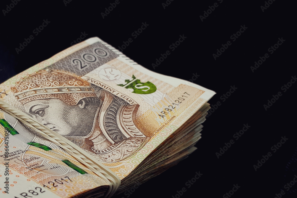 Stack of polish money. Business and financial concept. Polish Zloty banknotes isolated on black background. Stack of polish money. Business and financial concept. Polish Zloty banknotes isolated on black background.