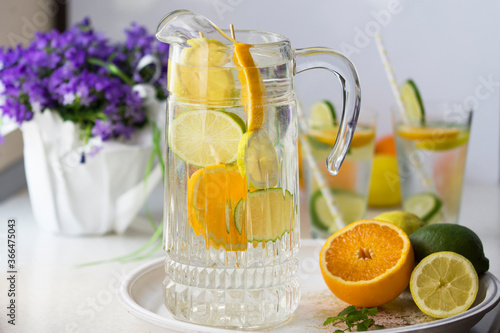 Water with fresh orange, lemon and lime slices.