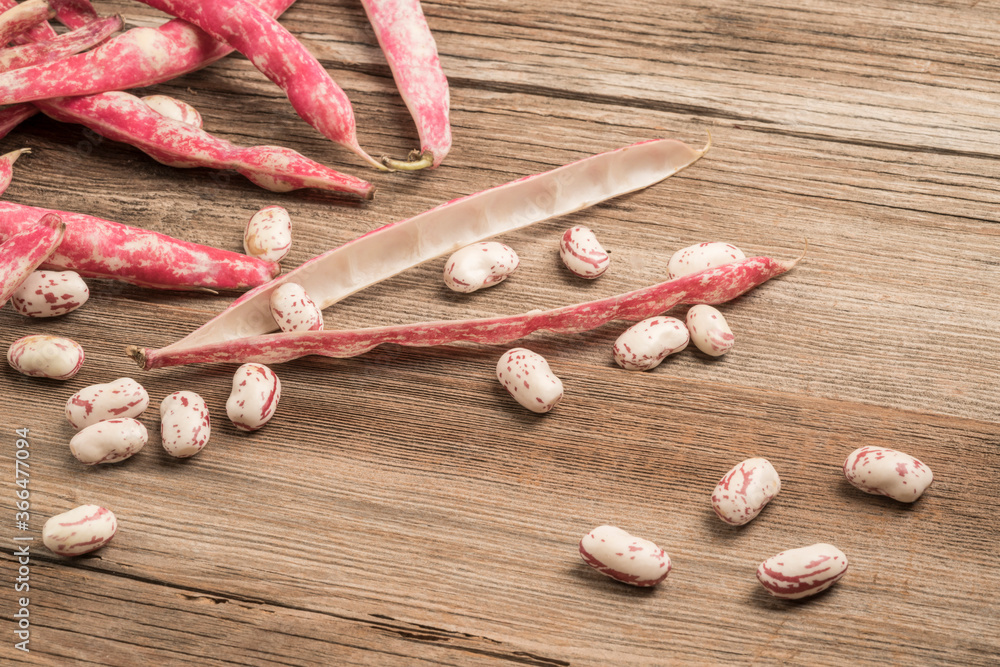 raw kidney beans on a wooden table raw kidney beans on a wooden table