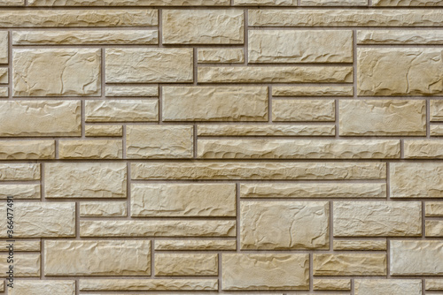 Wall with decorative tiles in the form of beige brickwork