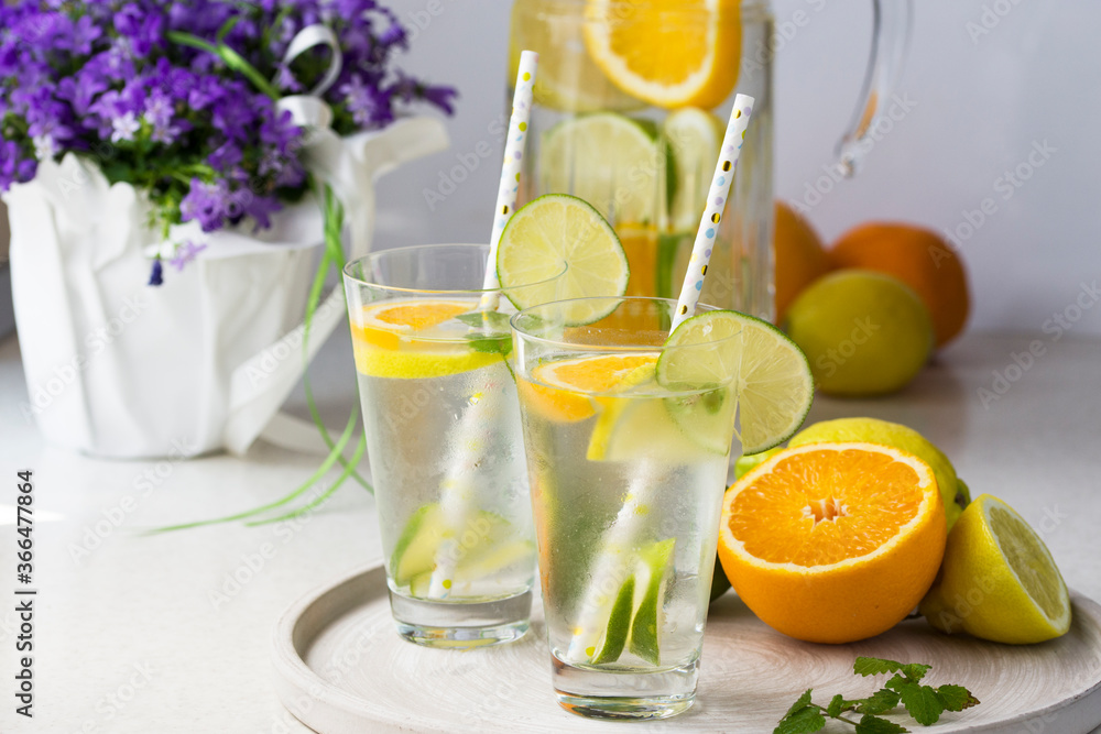 Water with fresh orange, lemon and lime slices. Water with fresh orange, lemon and lime slices.