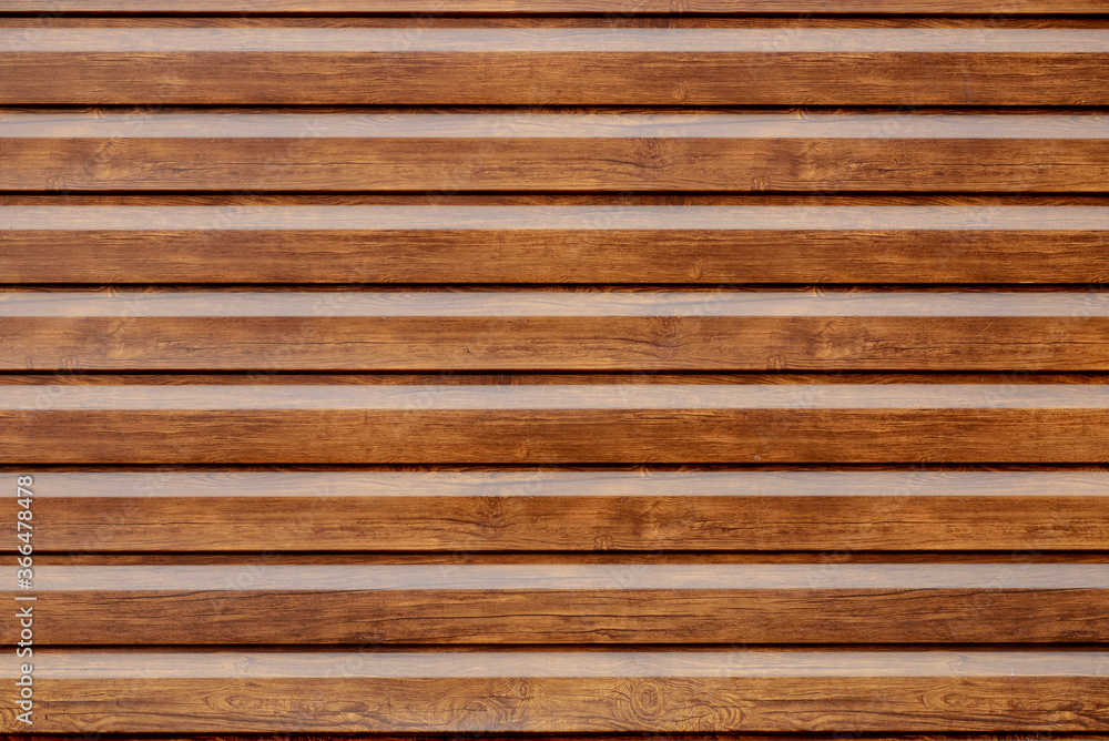 The wall of a modern building made of orange brick, decorative inserts imitating a brown wooden planks The wall of a modern building made of orange brick, decorative inserts imitating a brown wooden planks