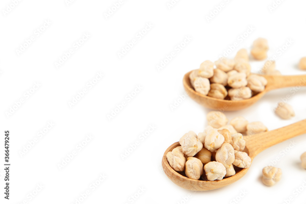 Uncooked chickpeas in wooden spoons isolated on white background Uncooked chickpeas in wooden spoons isolated on white background