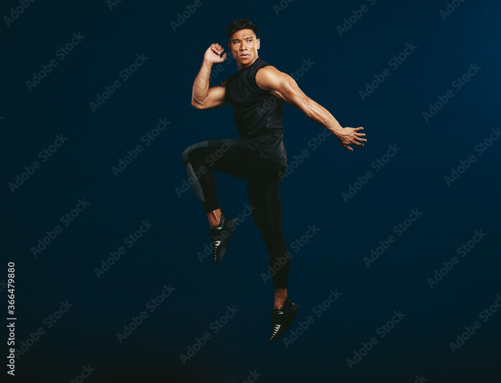 Sportsman doing jumping and stretching workout