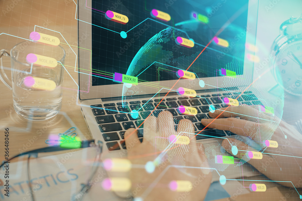 Multi exposure of world map hologram with man working on computer on background. Concept of worldwideweb.