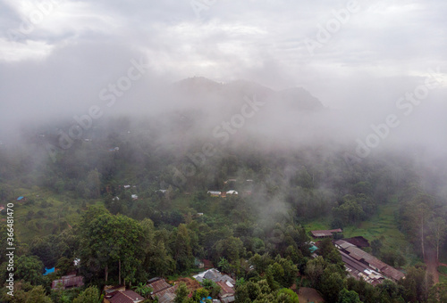 Aerial Drone Shot Flying by Cloudy Misty Foggy Lushoto village in Usambara Mountains. Remote Place in Tanga Province, Tanzania, Africa