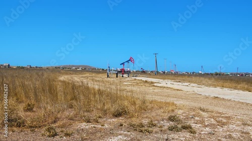 Oil rig pumping oil in 4k (UHD)