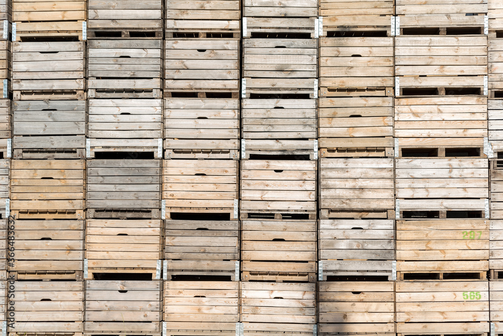 Wooden fruit boxes stacked on top of each other. Fruit containers prepared before harvest.