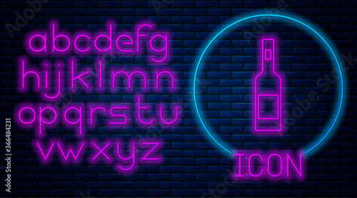 Glowing neon Glass bottle of vodka icon isolated on brick wall background. Neon light alphabet. Vector.