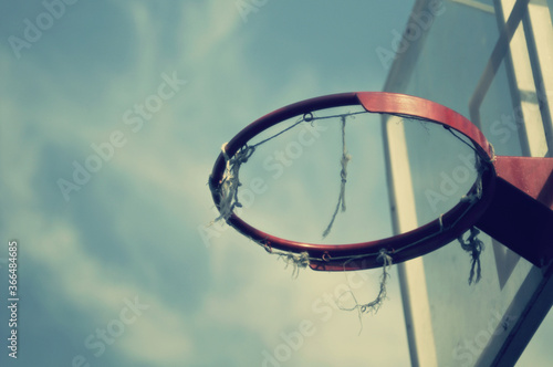 old basketball hoop against the sky