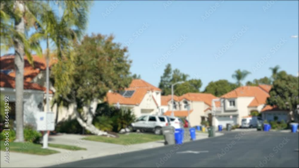 Suburb real estate, property in residential district, San Diego county, California USA. Defocused typical suburban neighborhood. Detached single-family houses, expensive realty. Row of classic homes. Suburb real estate, property in residential district, San Diego county, California USA. Defocused typical suburban neighborhood. Detached single-family houses, expensive realty. Row of classic homes.