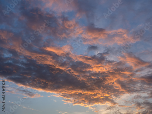 Fototapeta Naklejka Na Ścianę i Meble -  Evening sky with blue, white and orange clouds