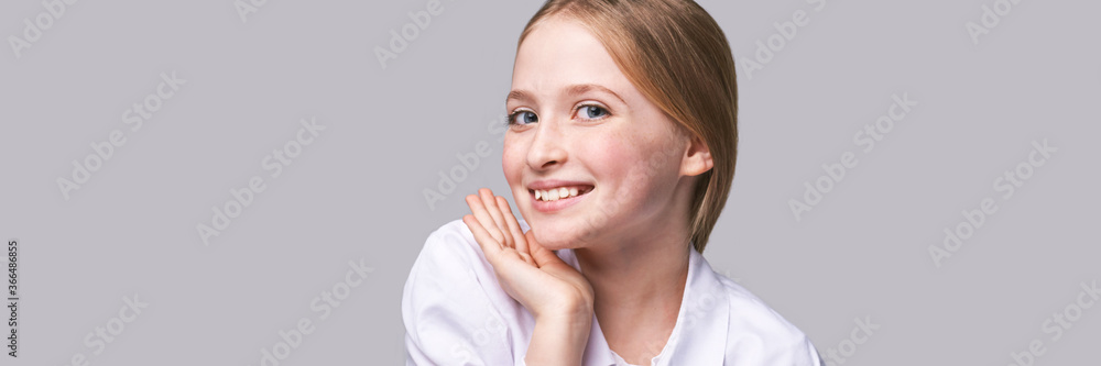 Beauty girl portrait. Young woman. Hand near nead. Face massage concept. White shirt. Cosmetology facelift laser. Medical rejuvenation scrub. Skin care hygiene. Grey background. Horizontal banner Beauty girl portrait. Young woman. Hand near nead. Face massage concept. White shirt. Cosmetology facelift laser. Medical rejuvenation scrub. Skin care hygiene. Grey background. Horizontal banner