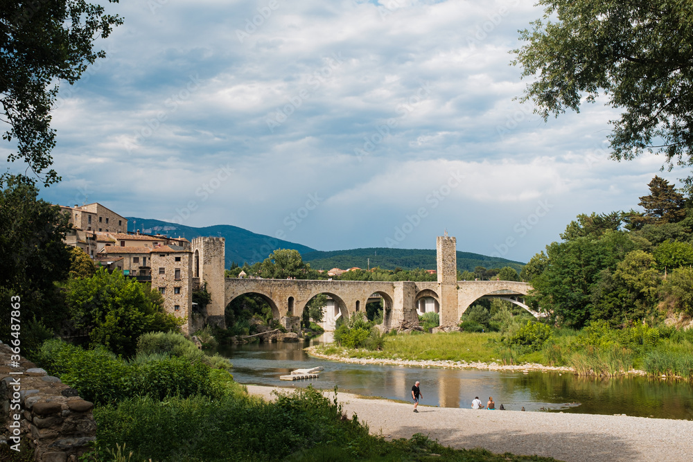Medieval stone bridge over a river in Besalu, Catalonia famous touristic landmark