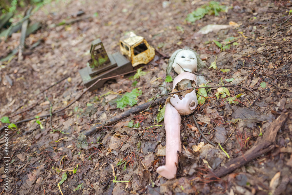 broken doll and smashed toy truck on radioactive ground