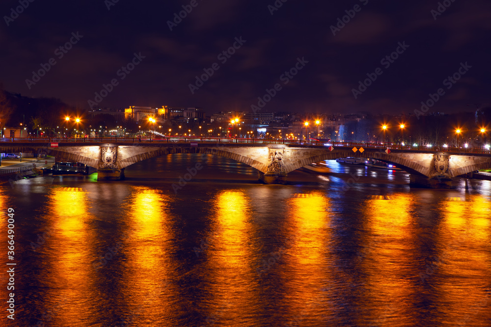 Pont des Invalides In the night illumination . Night view of Seine river and bridge in Paris 