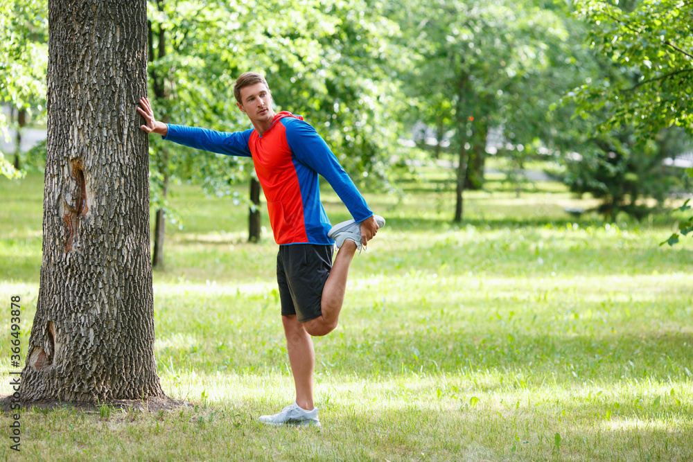 Jogger man stretcing muscles outdoor - sport and healthy lifestyle concept. Jogger man stretcing muscles outdoor - sport and healthy lifestyle concept.