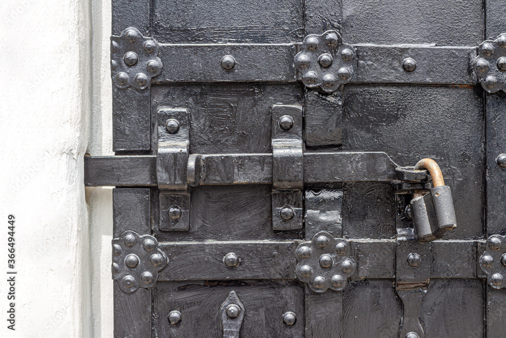 An old metal door with a lock in a merchant's house of the XVI century