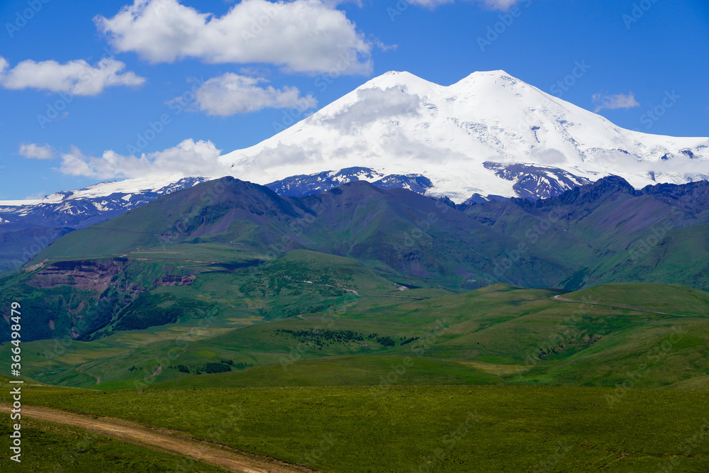 Panorama Mount Elbrus with Green Meadows at Summer. North Caucasus, Russia