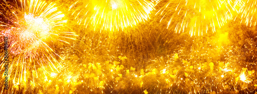 Wide festive background with yellow fireworks