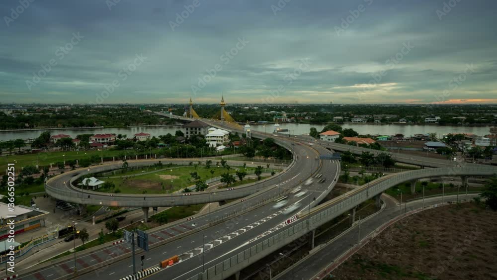 Aerial Time Lapse of highway with overpass and interchanges next to downtown during sunset. Aerial Time Lapse of highway with overpass and interchanges next to downtown during sunset.
