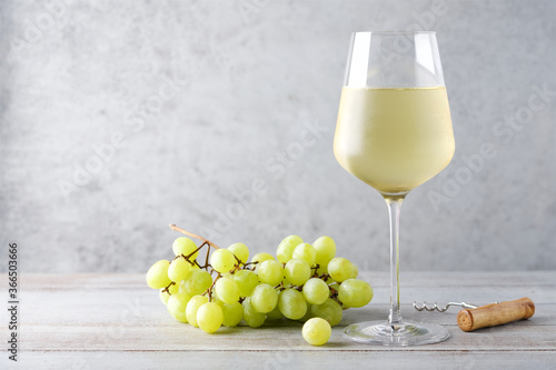 Misted glass of cold white wine on gray background