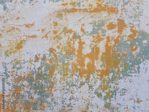 Damaged wall texture. Yellow and light green paint peeling off the wall.
