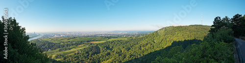 Panoramic view from Leopoldsberg over the hills of Vienna Woods with Kahlenberg and the city in the morning.