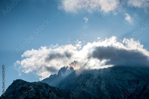 clouds surrounding the peak of a mountain on Grimselpass © schame87