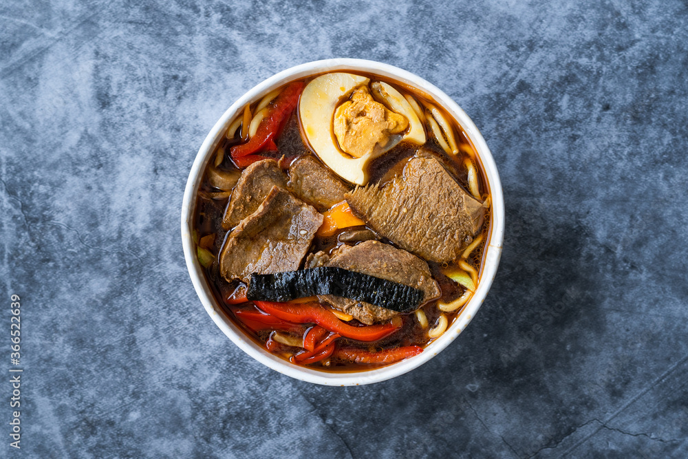 Take Away Shoyu Ramen Noodle with Egg, Soy Sprouts, Veal Meat, Carrot, Onion, Seaweed Wakame, Japanese Radish and Soy Sauce in Plastic Bowl. Take Away Shoyu Ramen Noodle with Egg, Soy Sprouts, Veal Meat, Carrot, Onion, Seaweed Wakame, Japanese Radish and Soy Sauce in Plastic Bowl.