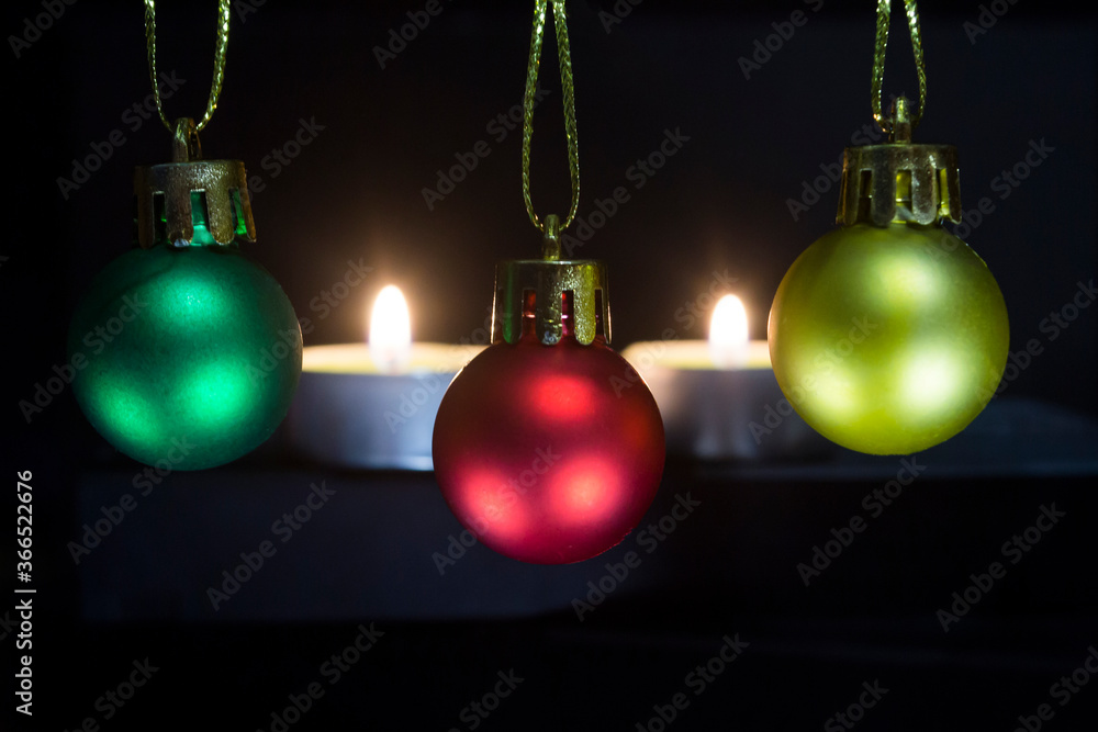New Year's toys on the background of burning candles. New Year's toys on the background of burning candles.