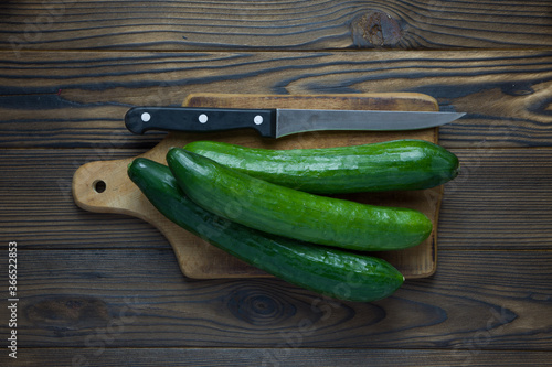 cucumber and knife on cutting board