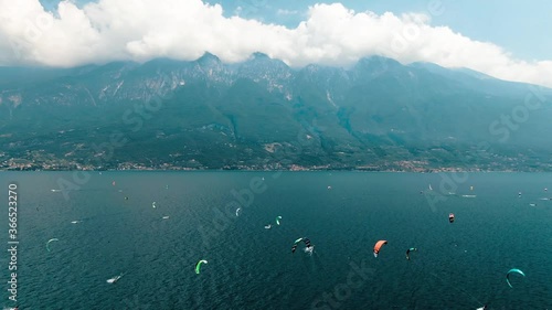Kitesurfing in front of mountains, lake Garda