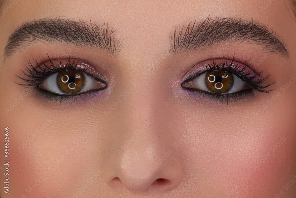 Macro shot of woman's beautiful eye with extremely long eyelashes. Sexy view, sensual look. Female eye with long eyelashes Macro shot of woman's beautiful eye with extremely long eyelashes. Sexy view, sensual look. Female eye with long eyelashes