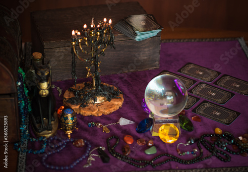 Tarot cards, Concept of fortune telling and predictions, magical rituals and wicca elements on a table © T.Den_Team