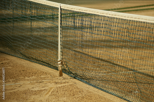Tennis net and sand tennis court © vitleo