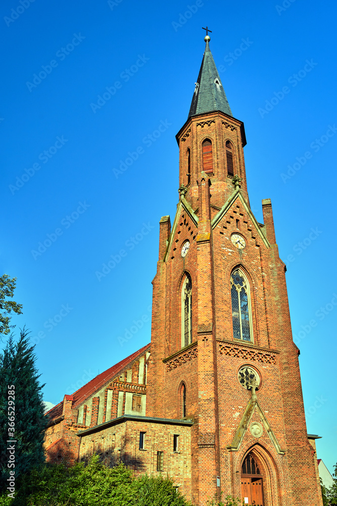 The tower of the historic, neo-Gothic red brick church in the village of Sokola Dabrowa
