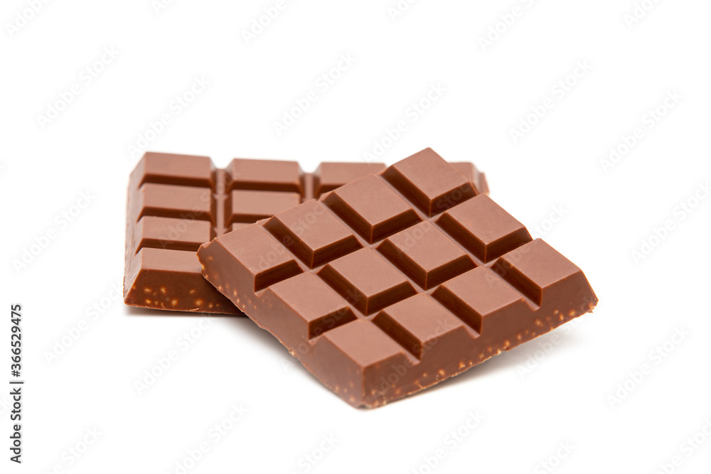 Milk chocolate pieces isolated on white background Milk chocolate pieces isolated on white background