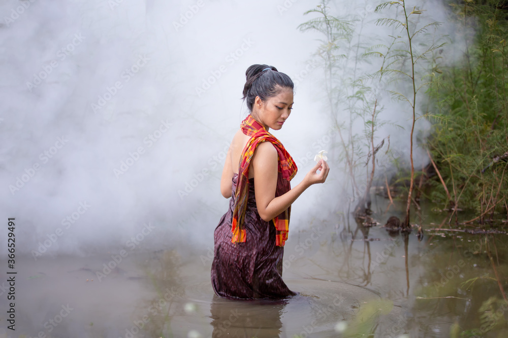Beautiful Asian women are bathing in the river. Asia girl in Thailand