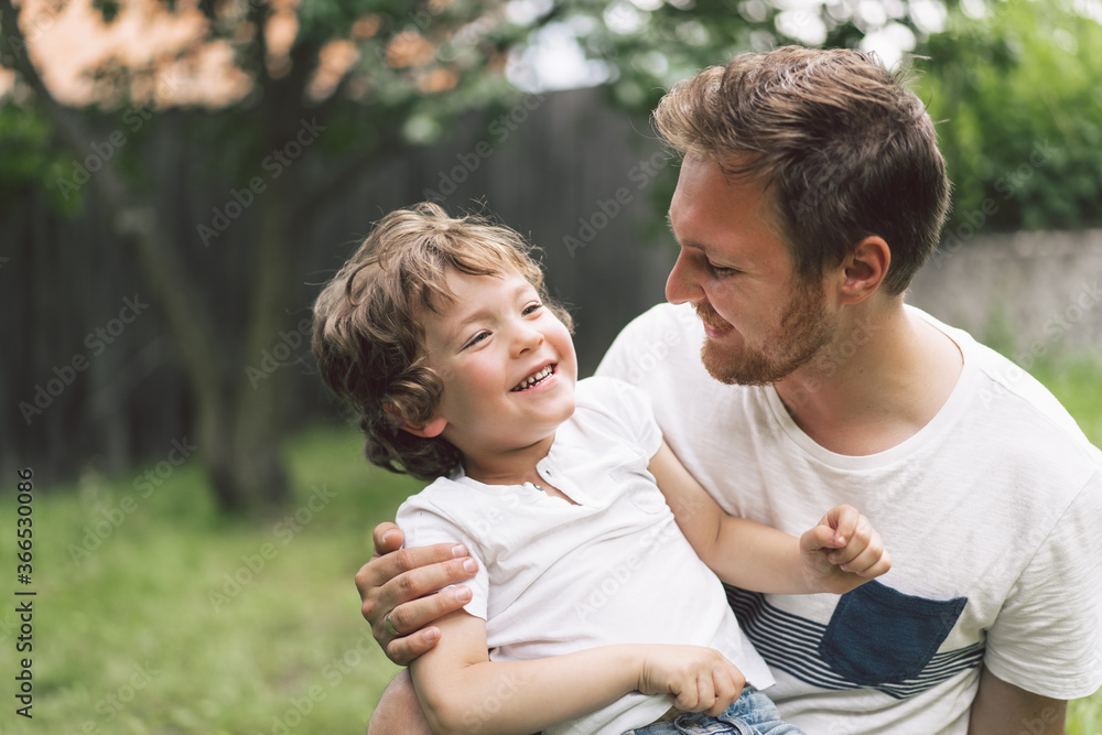 Father and his son playing and hugging in outdoors. Concept of Father's day. Father and his son playing and hugging in outdoors. Concept of Father's day.