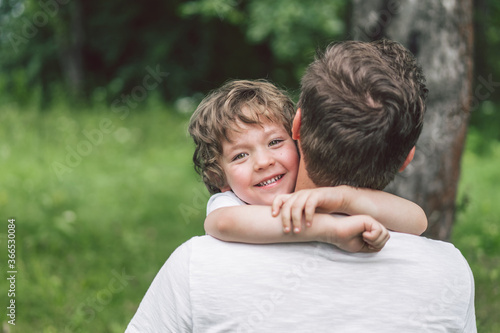 Father and his son playing and hugging in outdoors. Concept of Father's day. 