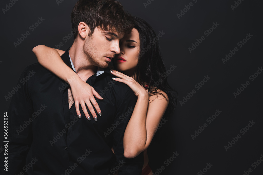 seductive woman hugging boyfriend isolated on black seductive woman hugging boyfriend isolated on black