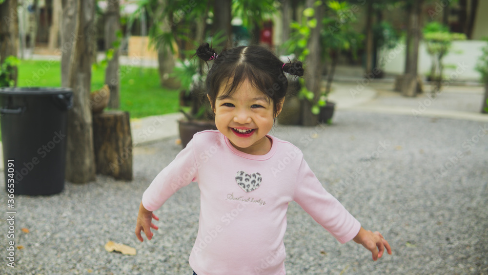 Asian little girl running and walking on grass field. Asian little girl running and walking on grass field.