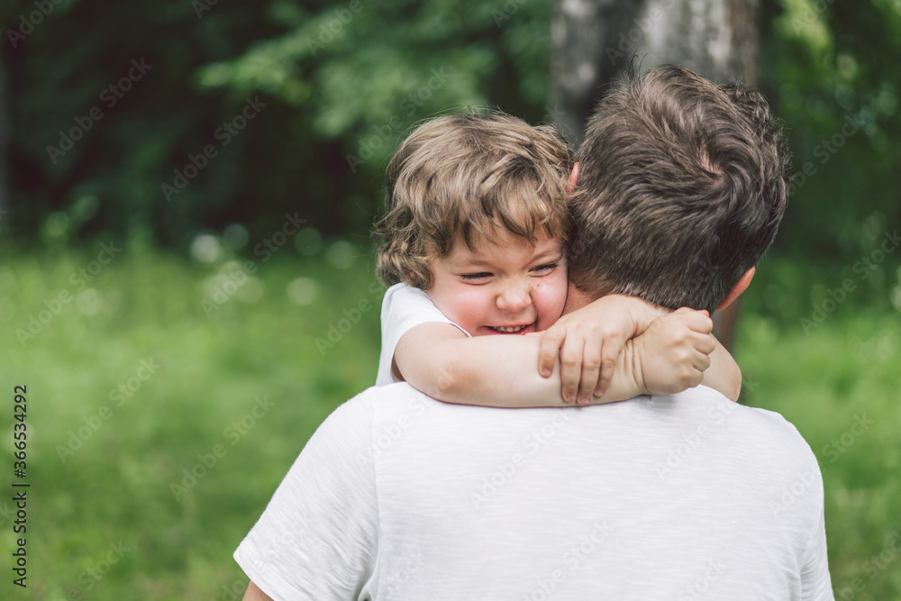 Father and his son playing and hugging in outdoors. Concept of Father's day. Father and his son playing and hugging in outdoors. Concept of Father's day.
