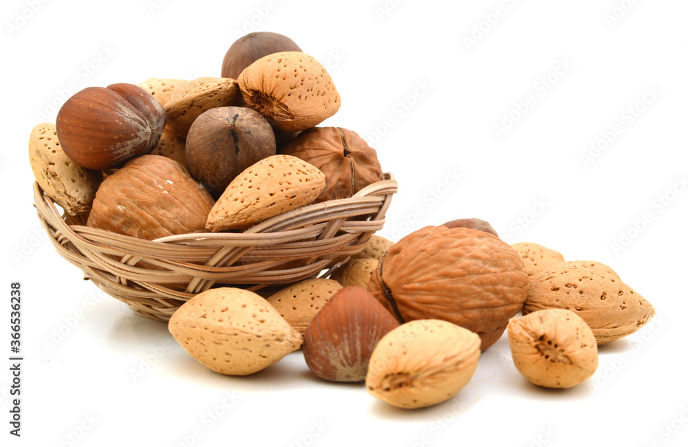 Mixed nuts selection of Brazil,almonds,waln ut and hazelnuts in basket on white Mixed nuts selection of Brazil,almonds,waln ut and hazelnuts in basket on white