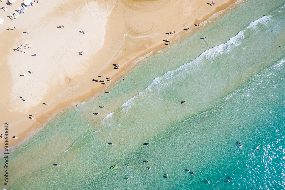 Aerial view of a shallow sandy beach and sunshade.Tourism and holiday concept.