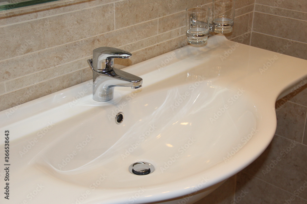 Modern white sink in the bathroom. Interior item Modern white sink in the bathroom. Interior item